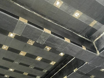 Carbon fiber retrofitting of concrete beams and slabs