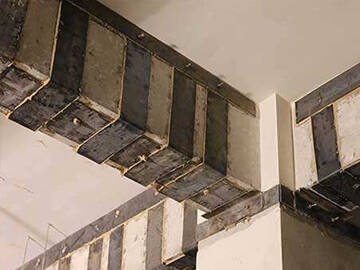 Reinforcement of beam and column with adhesive bonded steel plate