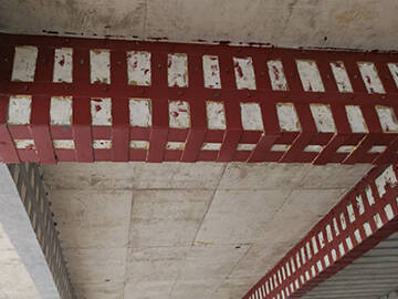 Reinforcement of building beams by adhesive bonded steel plate 