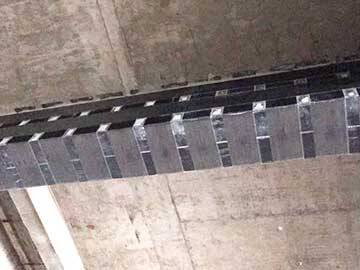 Reinforcement of beams by using carbon fiber reinforced polymer